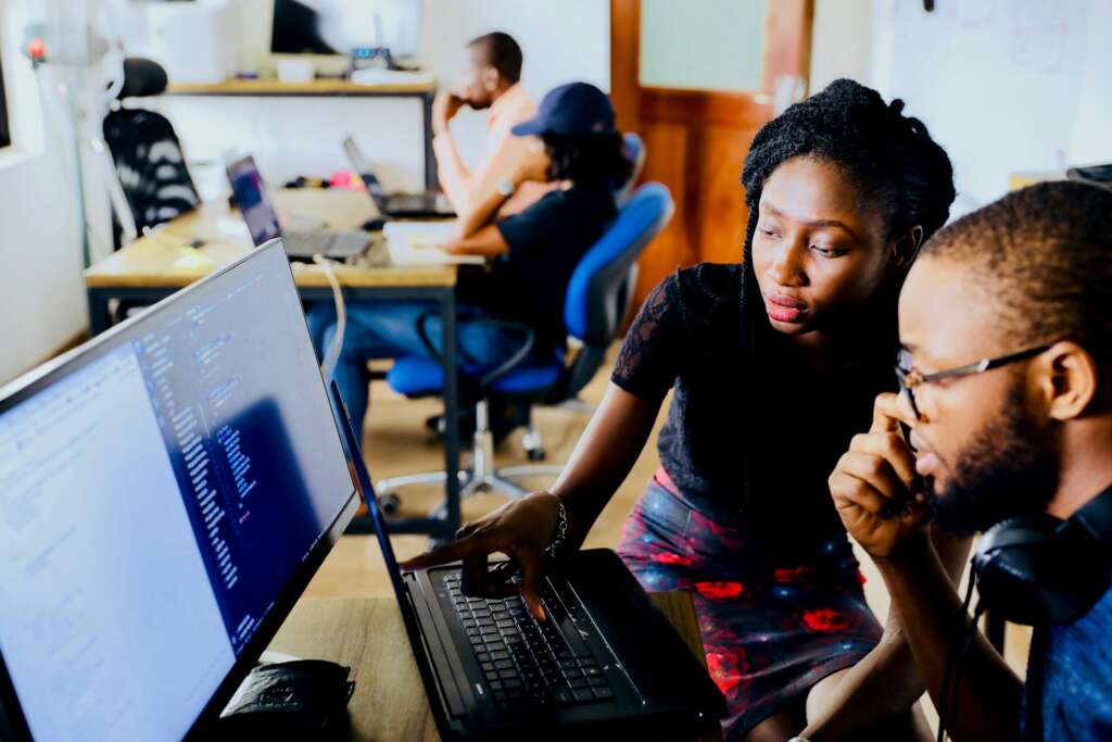 Young professionals working together at a computer