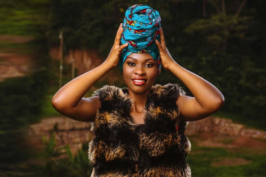 Woman adjusting a blue headwrap