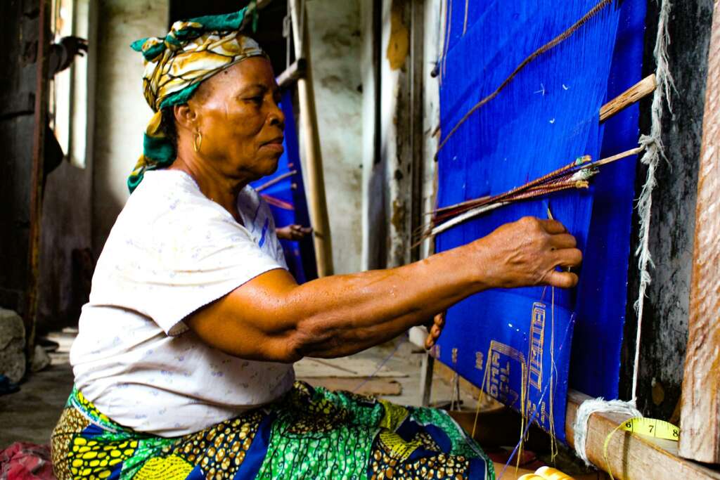 Woman weaving traditional cloth on a loom